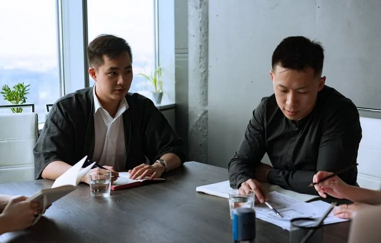 Rezolva going through a written quotation with a client in Singapore