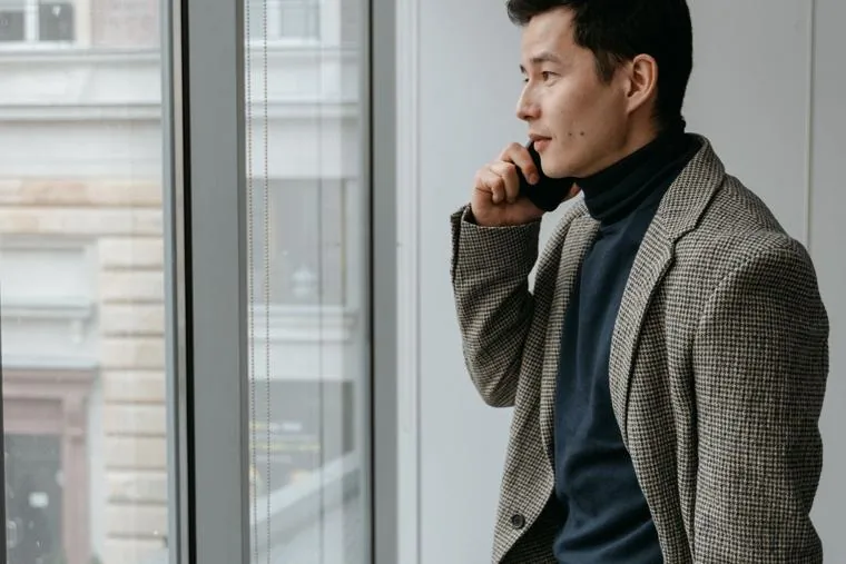 A Singapore staff member approving a sign-in on his phone, the second factor a takeover cannot pass