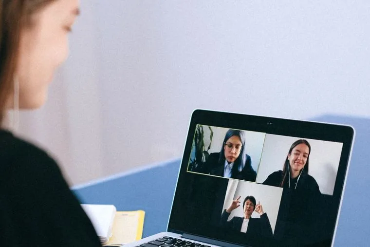 A Singapore staff member on a video call from a laptop that travels