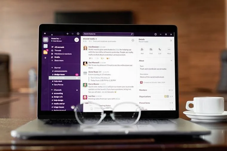 A laptop open on a team chat and document workspace where Copilot drafts and summarises