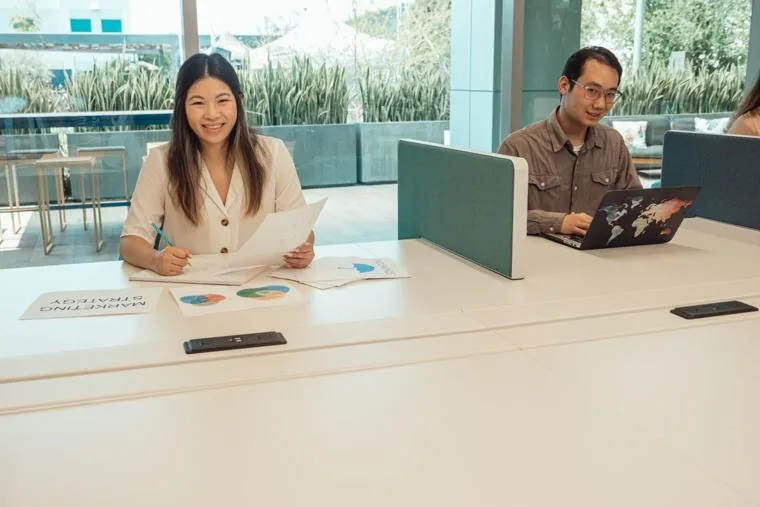 Two Singapore colleagues at their desks on the desktop Office apps