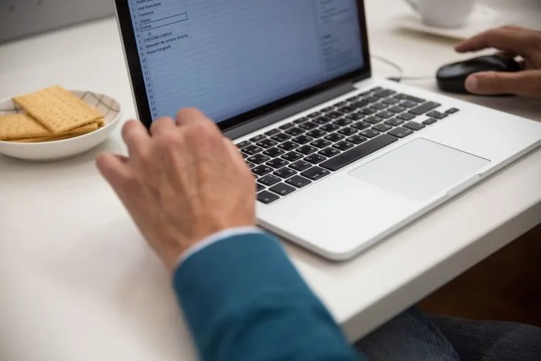Hands on a laptop keyboard, the seat that the ledger and the hotline are for