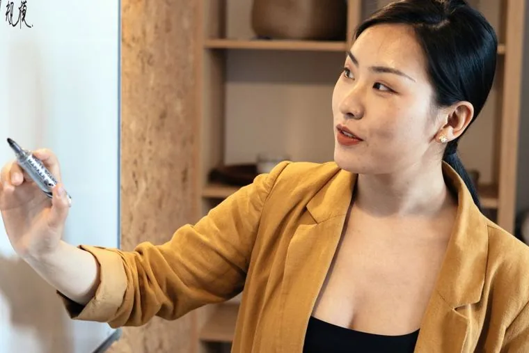 A Singapore manager pointing at a shared screen during a tenant review