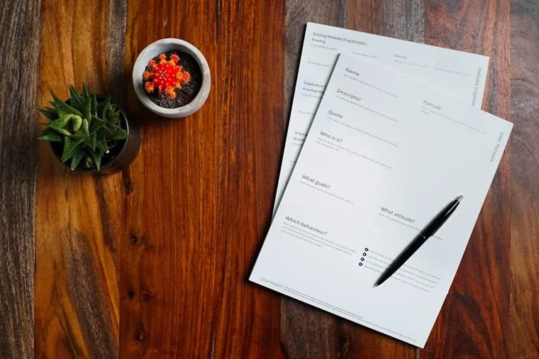 Procurement questionnaire and supplier paperwork on an office desk