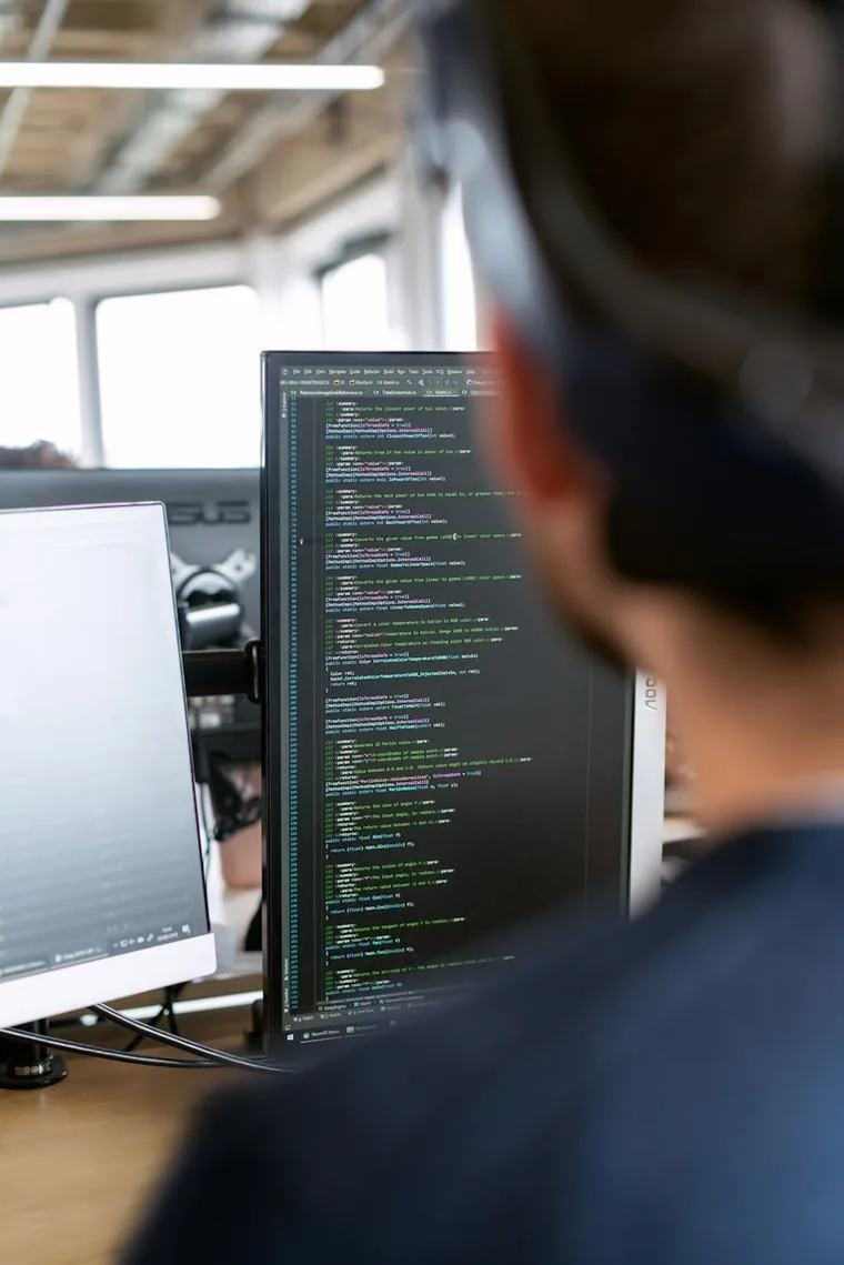 Security engineer working through exploitation chains on multiple screens