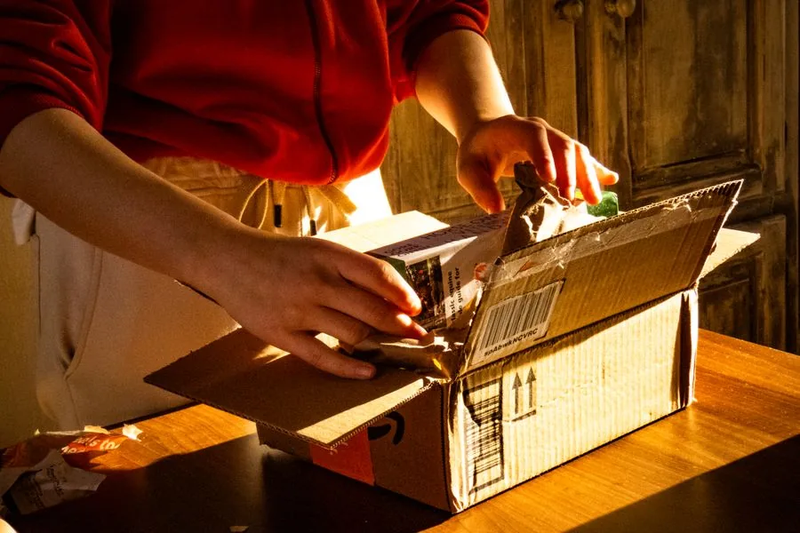 Cartons opened on a desk as new network hardware is counted in on delivery day