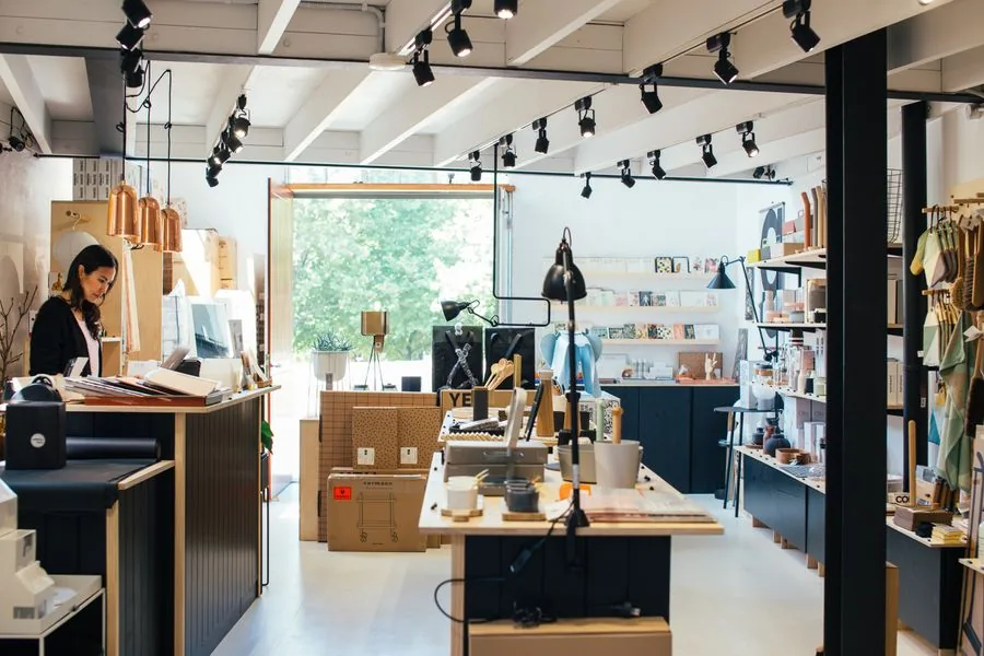 Bright retail interior with a service counter and shelved display units