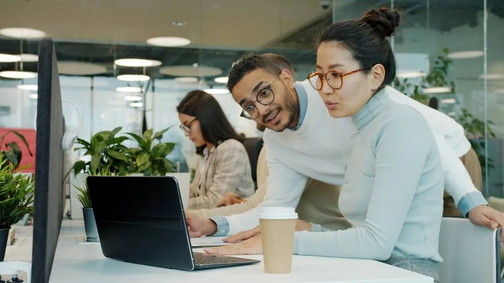 Staff working on managed laptops in a Singapore office